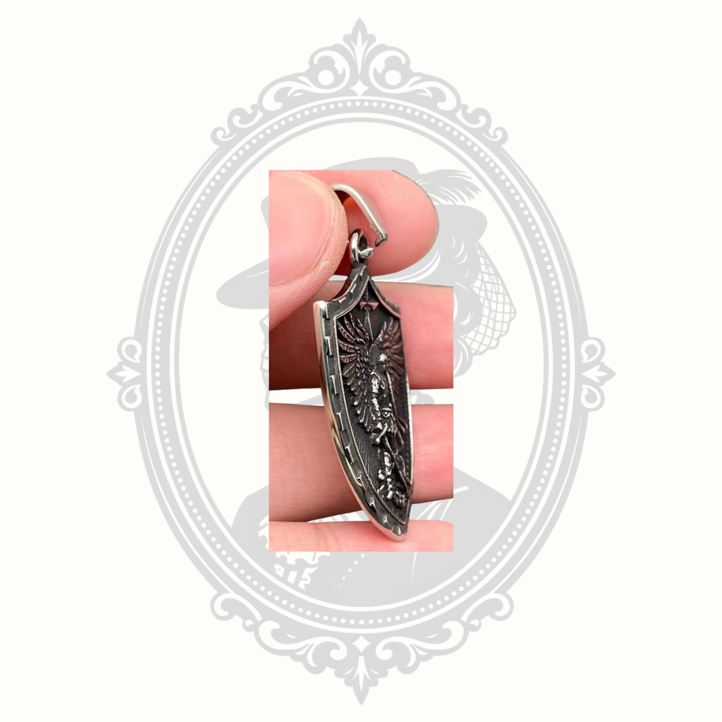 Close-up side view of the detailed Saint Michael Archangel shield pendant with vintage blackened finish.