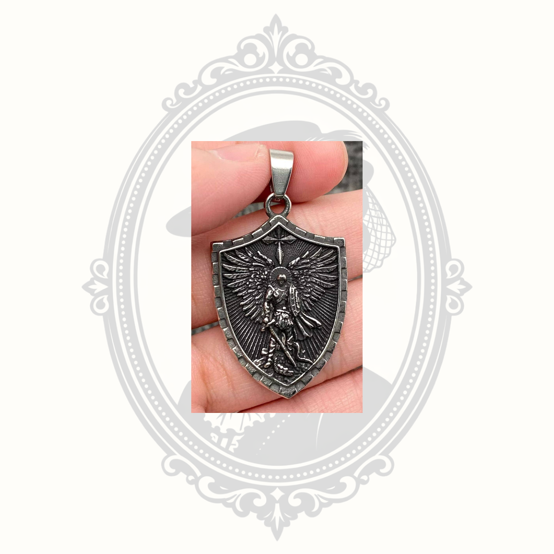 Saint Michael Archangel shield pendant displayed in hand showing the detailed front design.