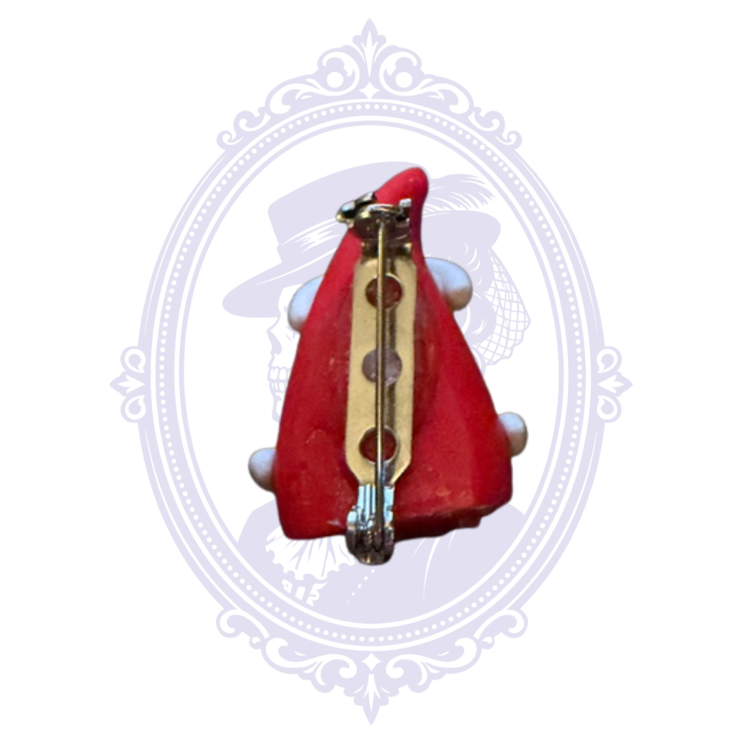 Back of Santa Claus Christmas brooch showing metal pin clasp and dimensional red holiday jewelry design.