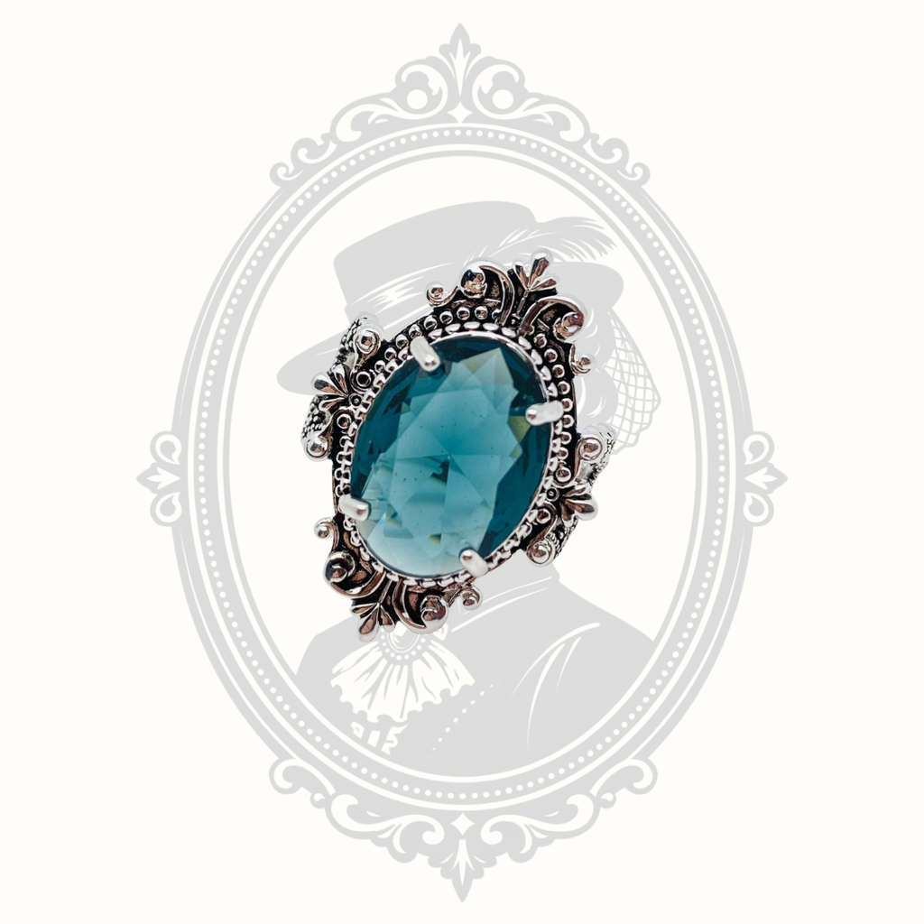 Front view of the vintage-inspired ring featuring a sea blue oval glass stone.