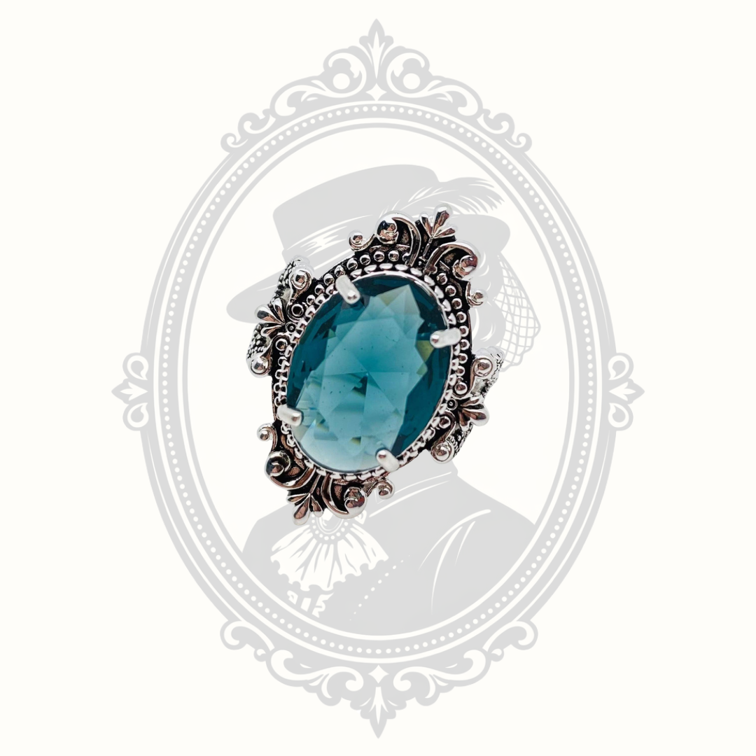 Front view of the vintage-inspired ring featuring a sea blue oval glass stone.