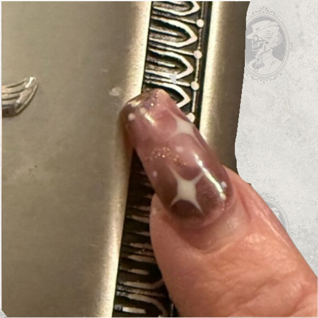 Detailed view of decorative etched border on vintage Selwyn pewter hip flask