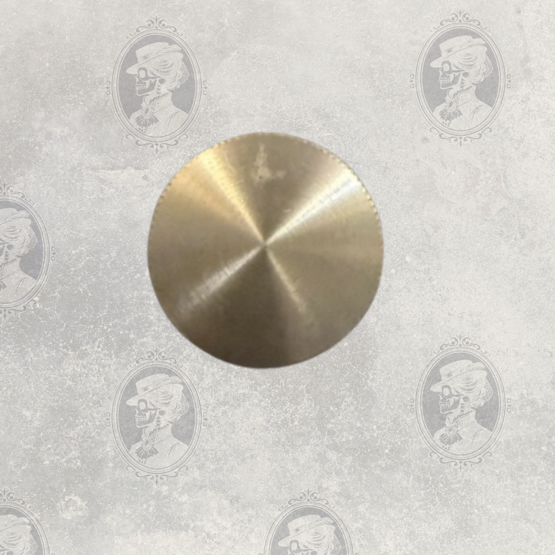 Close-up of round brushed metal cap on vintage Selwyn pewter hip flask