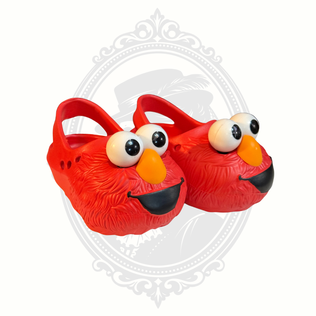 Pair of bright red Sesame Street Elmo kids clogs with oversized eyes and orange nose detail.
