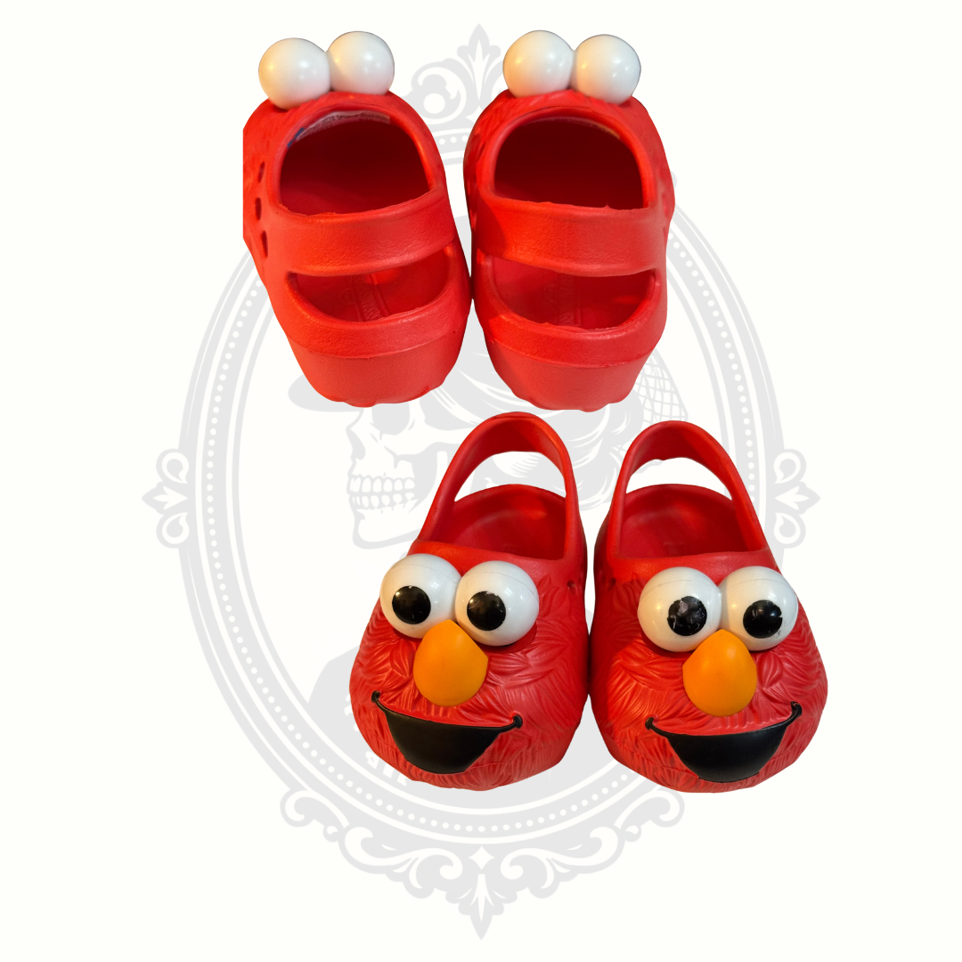 Front and back views of red Sesame Street Elmo kids slip-on clogs with heel straps.