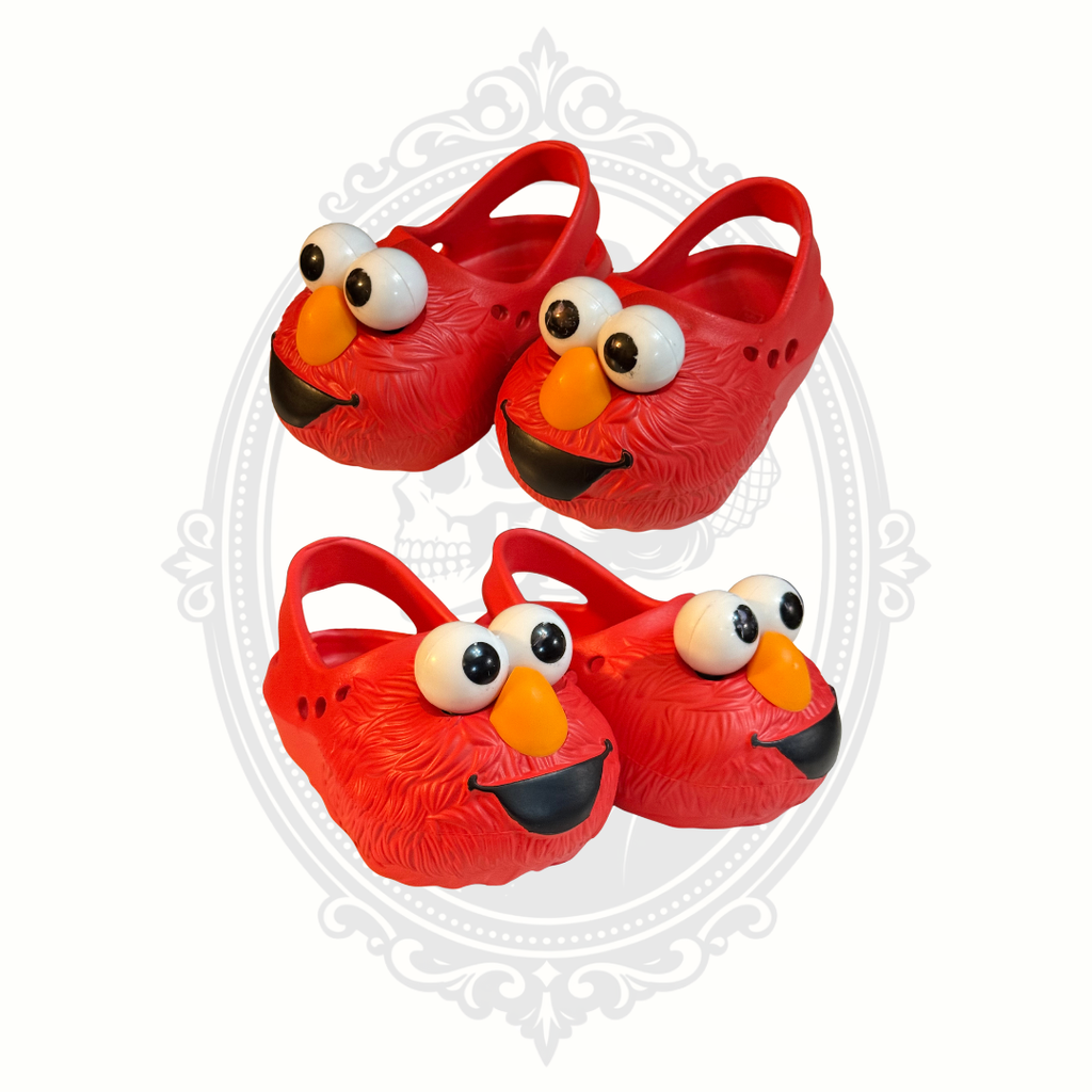 Multiple angled views of red Sesame Street Elmo clogs for kids showing character face details.