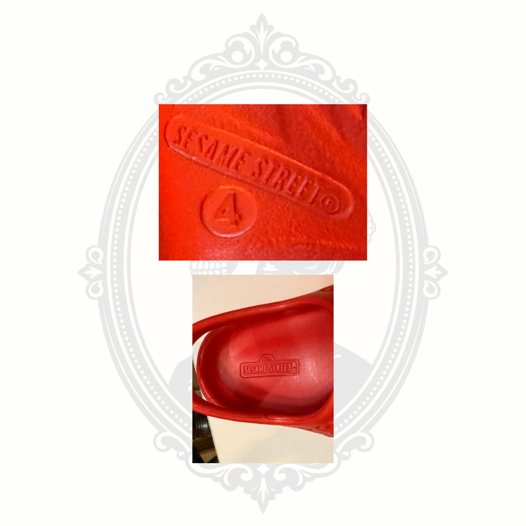 Close-up of Sesame Street branding and size 4 marking inside red Elmo kids clogs.
