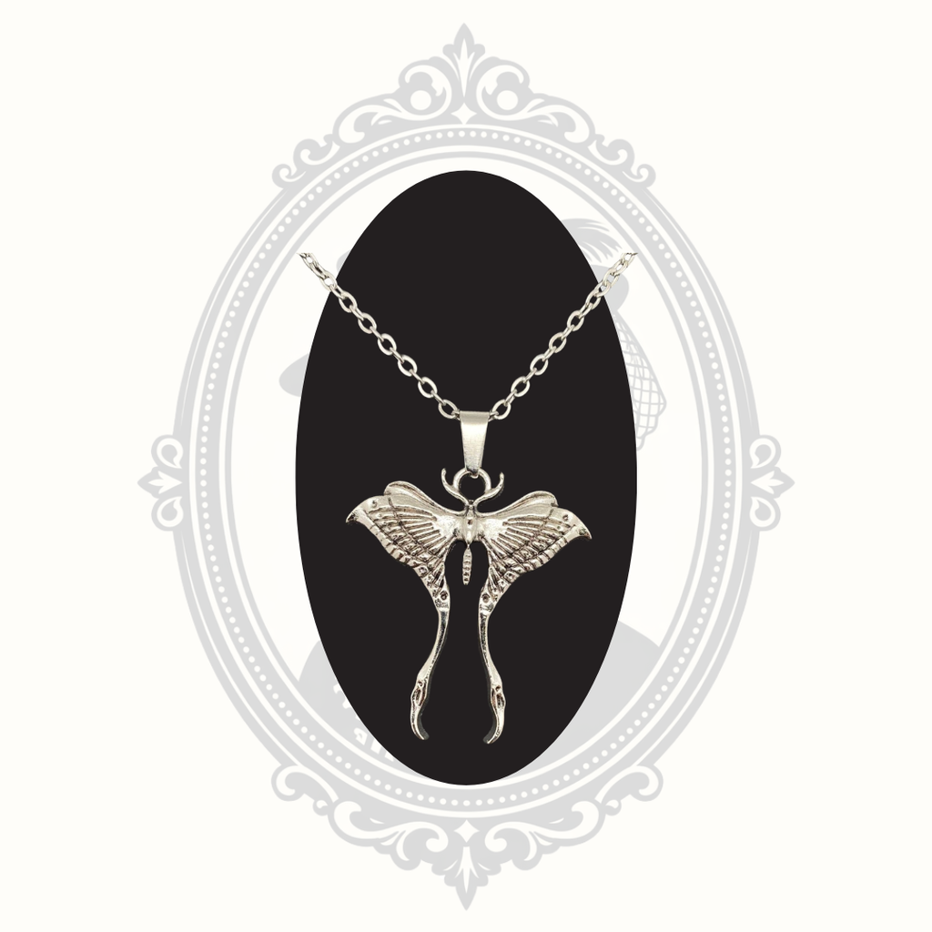 Close-up of a silver-tone Luna moth pendant necklace with detailed wing design.