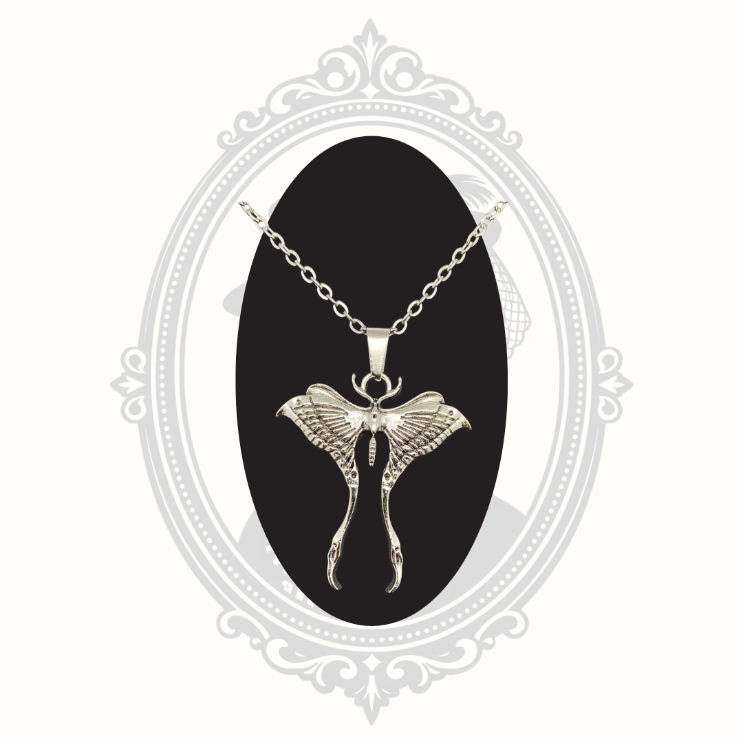 Close-up of a silver-tone Luna moth pendant necklace with detailed wing design.