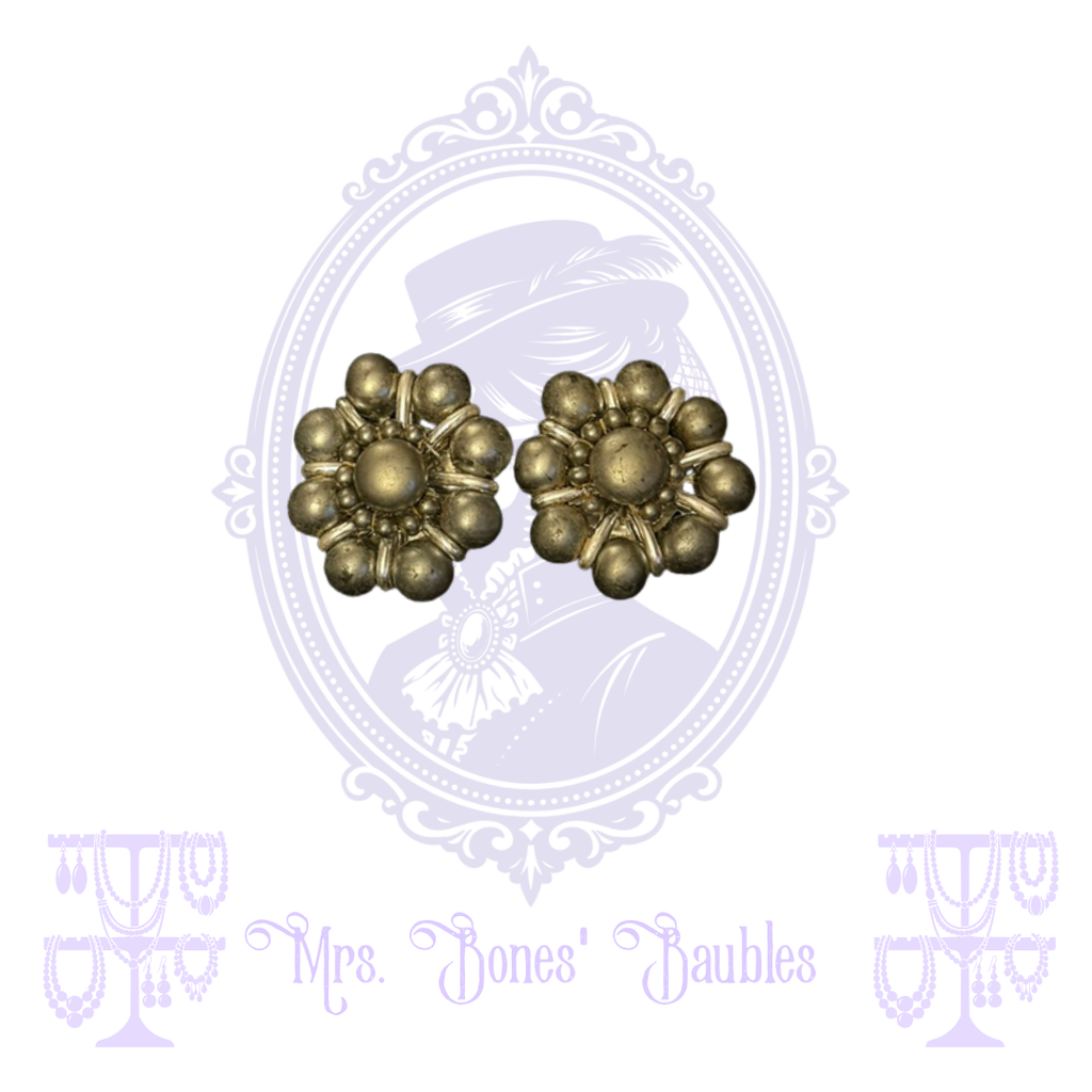 Silver-tone floral clip-on earrings with dimensional rounded petals and domed centers