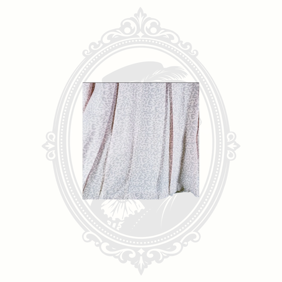 detail of pink leopard print pleated skirt showing lightweight fabric and pleats
