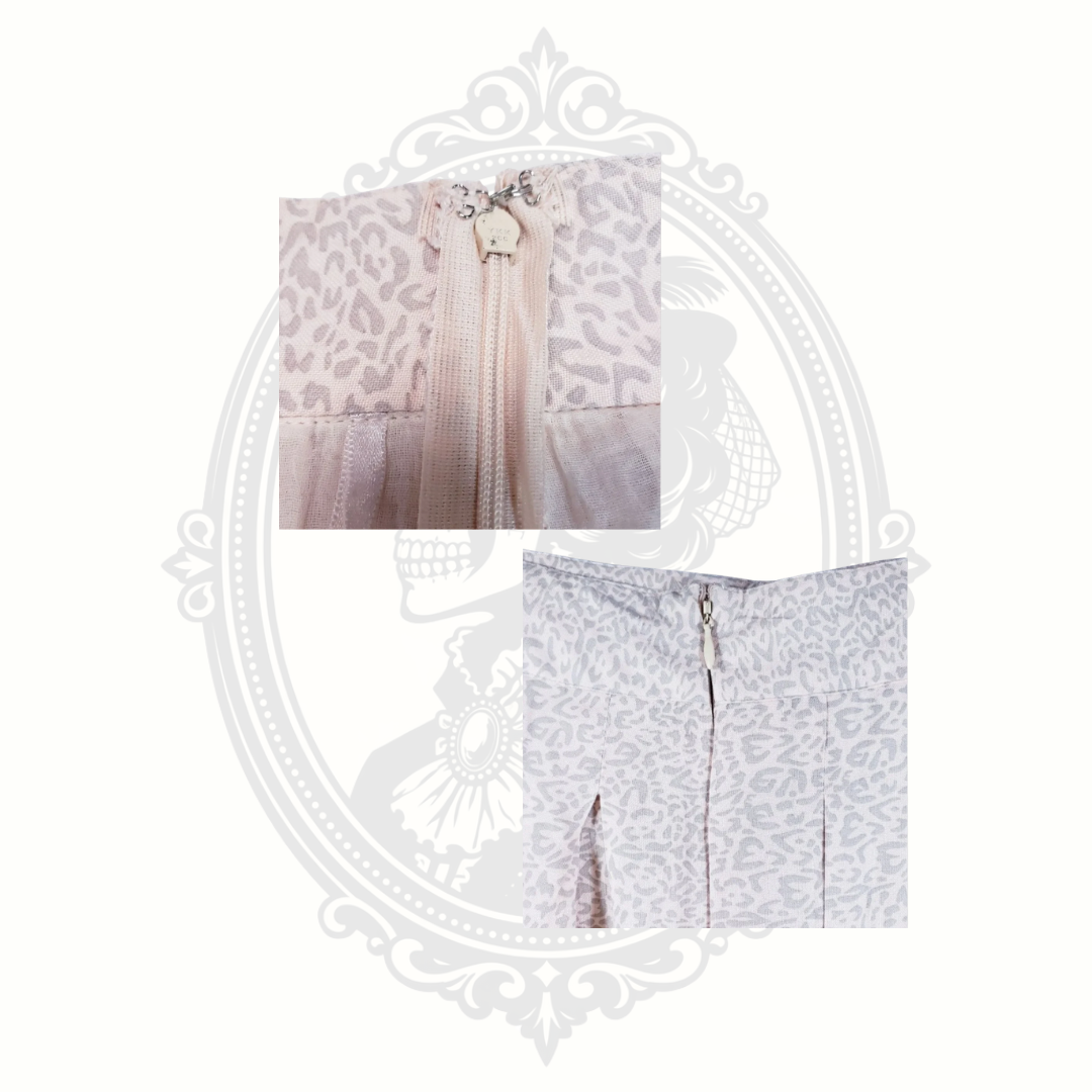 close up of Sim and Sam pink leopard print pleated skirt showing back zipper and waistband detail new with tags
