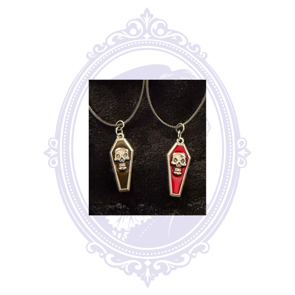 Two gothic skull coffin necklaces showing red and black pendant color options.