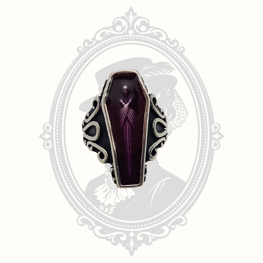 Gothic stainless steel coffin ring featuring a purple zombie coffin centerpiece.