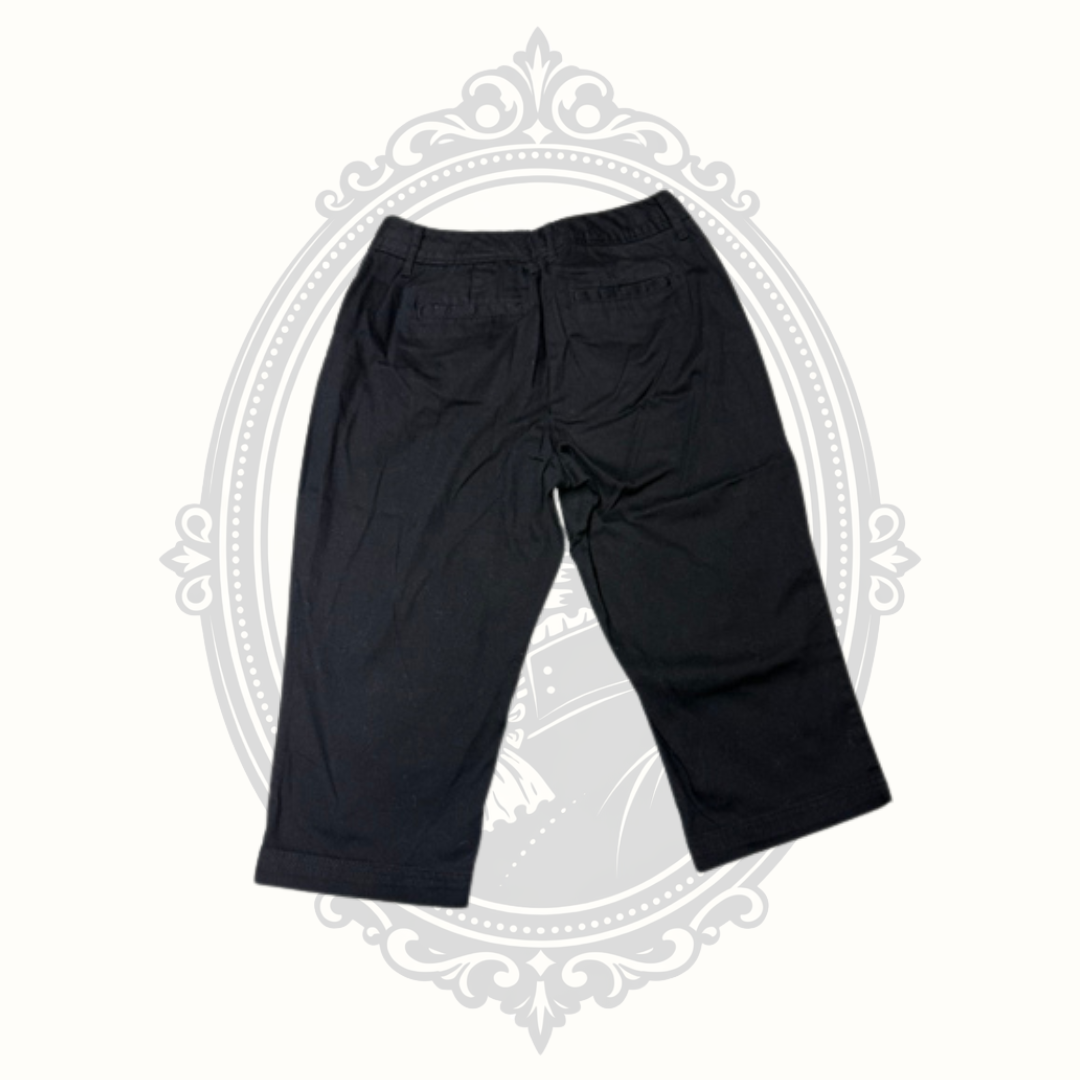 Black cropped pants with a relaxed straight-leg fit, displayed flat against a light cream background with a faint gray decorative frame.