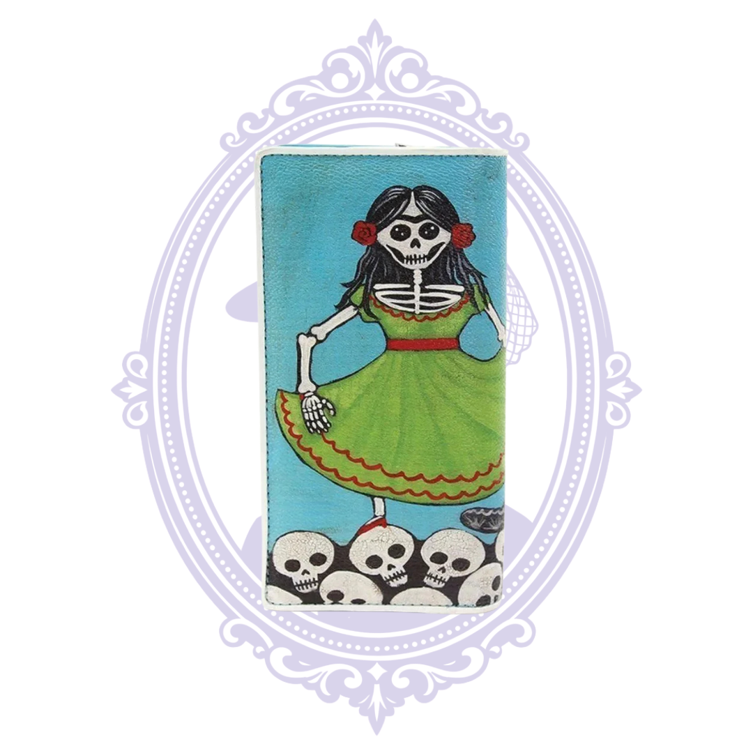 Close-up of turquoise vinyl sugar skull wallet showing skeleton woman in a bright green dress above a row of white skulls.