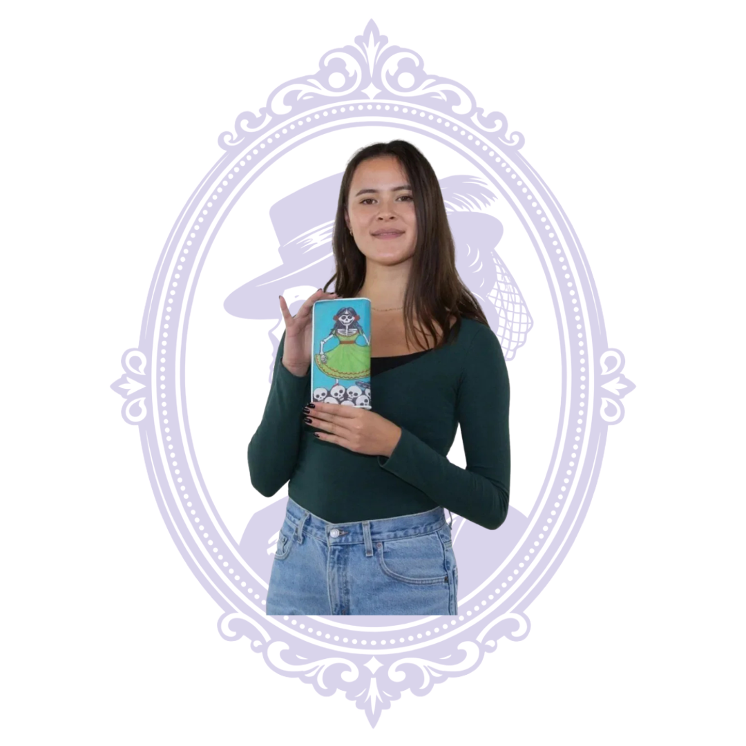 Model holding the turquoise vinyl sugar skull wallet vertically, showing the skeleton woman in a green dress and skull border.