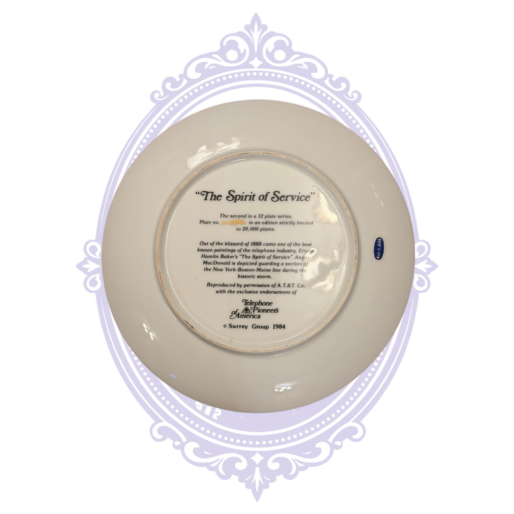 Reverse of 1984 The Spirit of Service Telephone Pioneers of America collector plate, second in a 12-plate series, with Blizzard of 1888 historical inscription, handwritten edition number, Surrey Group mark and Made in Japan sticker