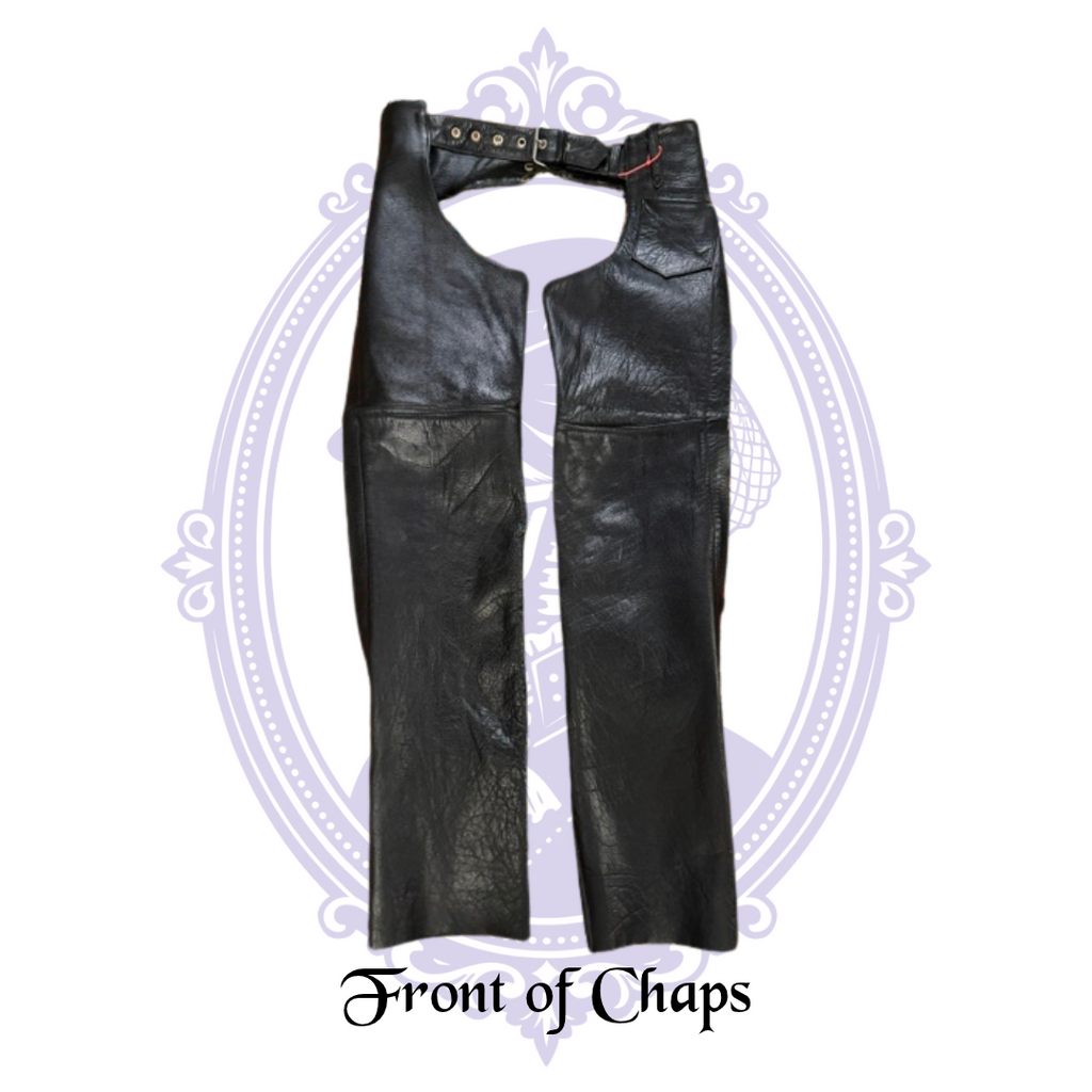 Front view of UNIK International black leather motorcycle chaps, size XS, with adjustable waist belt