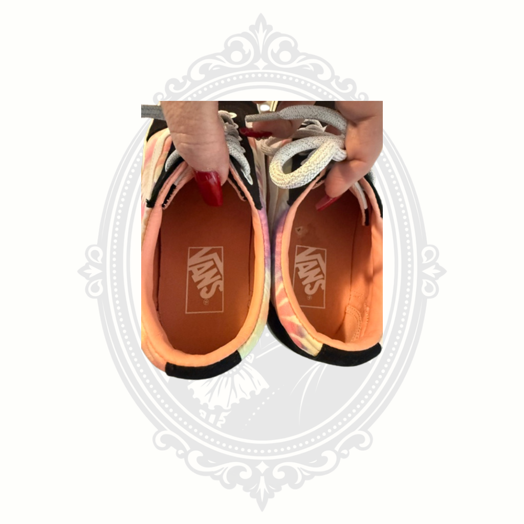 Interior view of VANS sneakers showing clean peach-colored insoles and VANS branding.