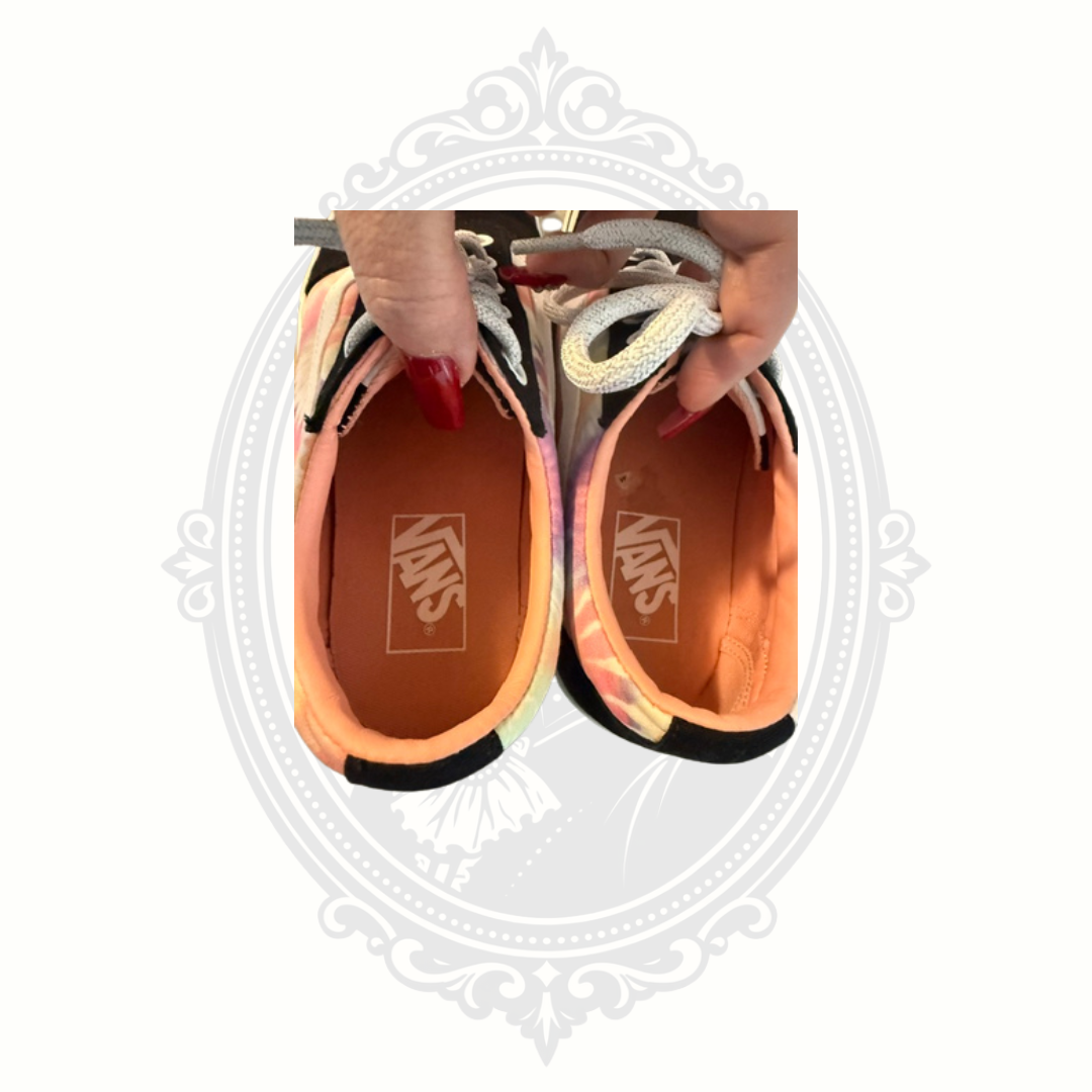 Interior view of VANS sneakers showing clean peach-colored insoles and VANS branding.