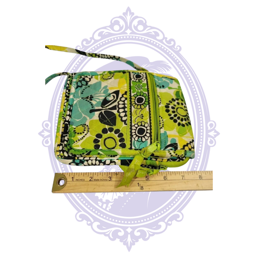 Side view of Vera Bradley Limes Up Mini Hipster crossbody beside ruler