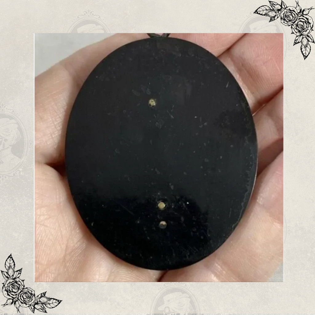 Back of antique Victorian cameo pendant in black gutta percha showing smooth surface and mounting points