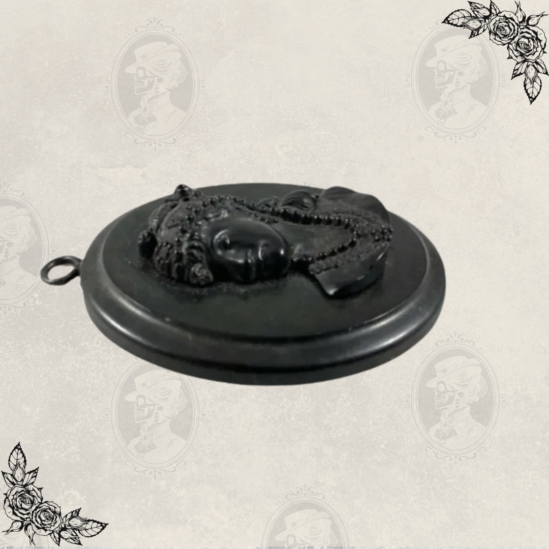 Side view of antique Victorian mourning cameo pendant showing loop for chain and raised relief carving
