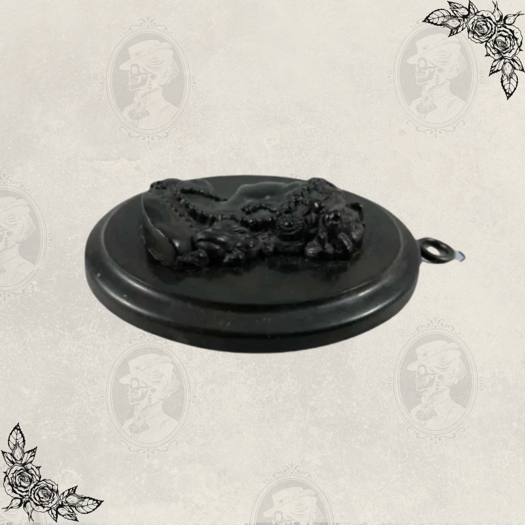 Low angle view of antique Victorian mourning cameo pendant highlighting depth and relief carving
