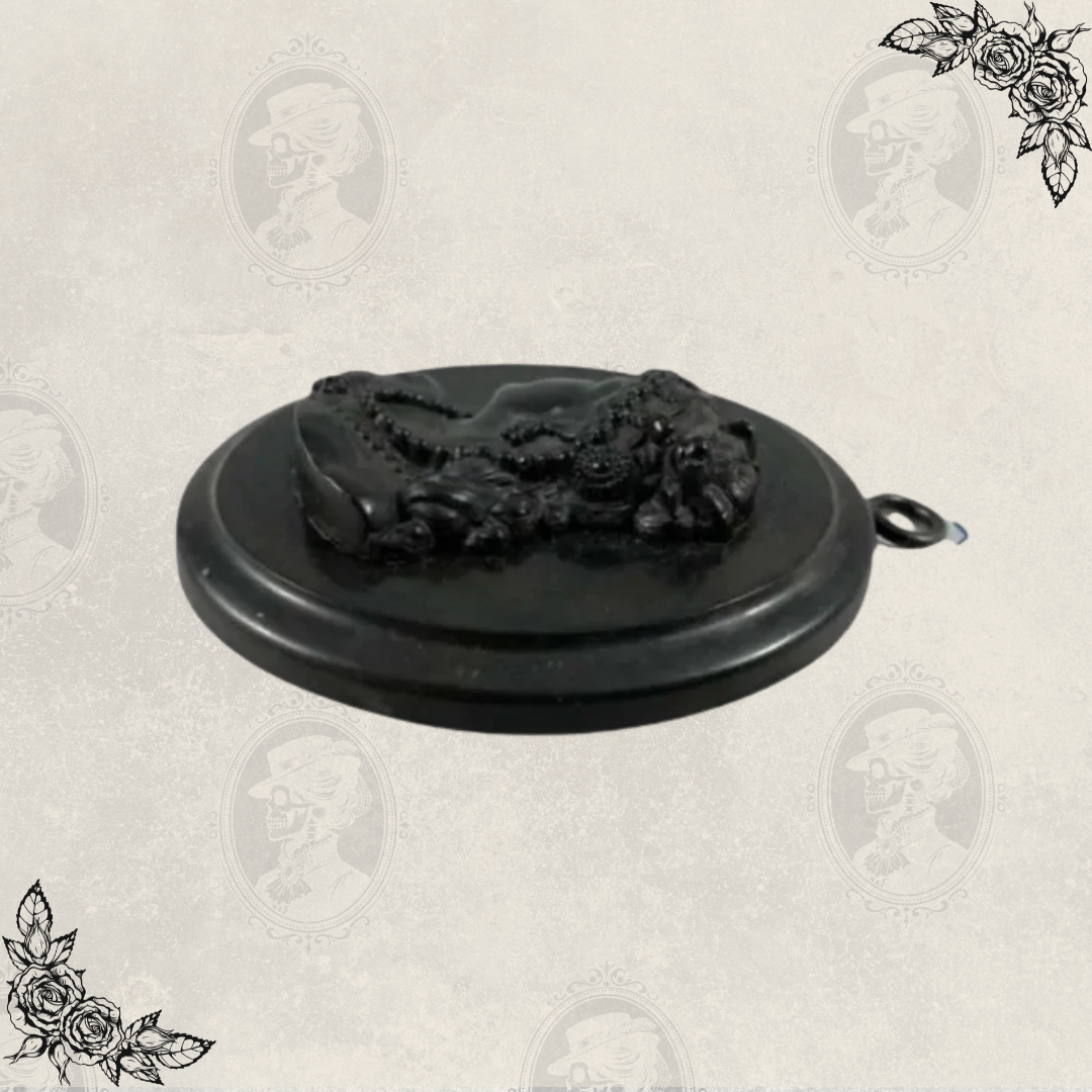 Low angle view of antique Victorian mourning cameo pendant highlighting depth and relief carving