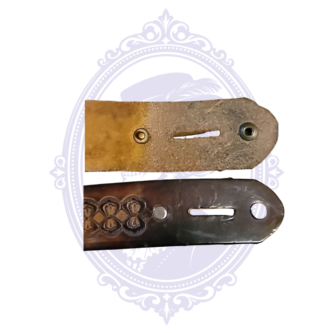 Front and reverse of the brown leather belt end showing buckle attachment holes and leather construction.