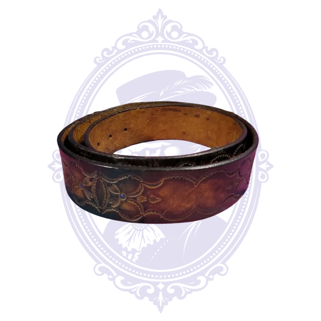 Coiled vintage brown leather belt with large floral tooling, small blue accent studs, scalloped borders, and tan leather underside.