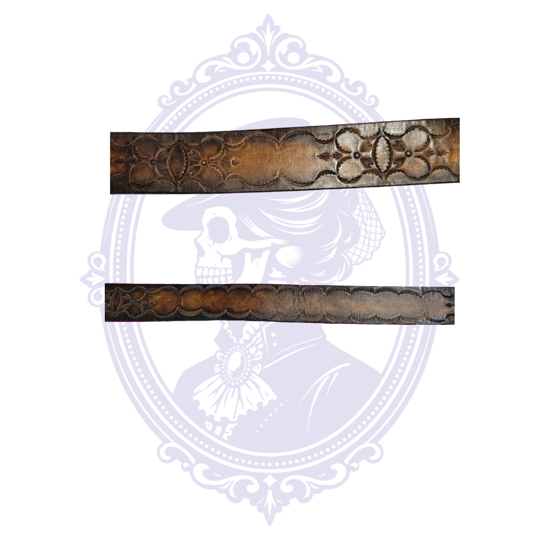 Two flat close-up views of brown leather belt with large tooled flower motifs, blue studs, and continuous scalloped detailing.