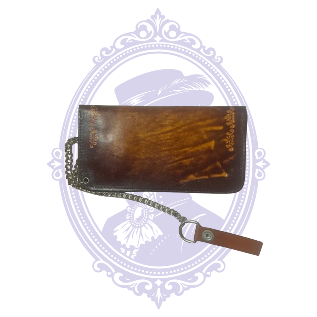 Back of vintage chestnut and dark brown leather chain wallet BBL-13 showing contrasting leather patina, floral corner tooling, chain and belt-loop strap.