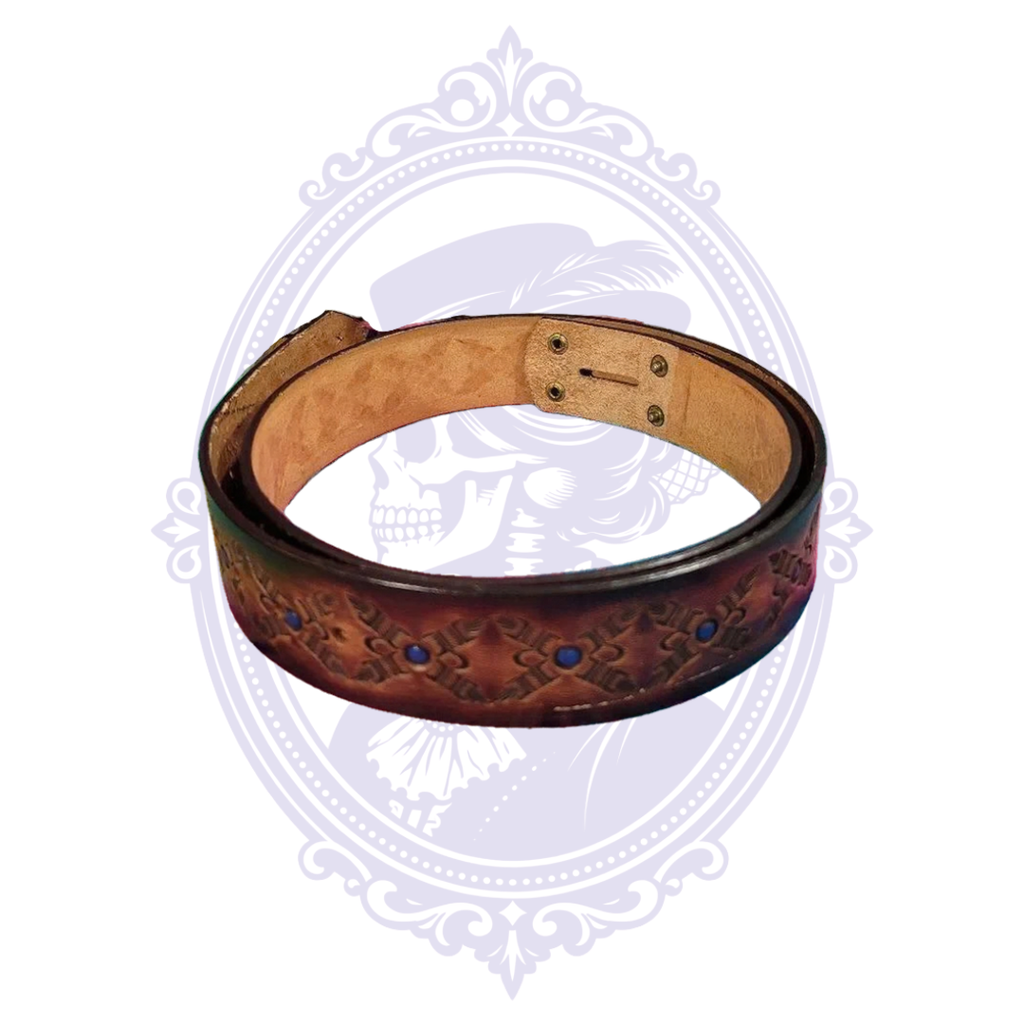 Coiled brown leather belt with repeating geometric tooled motifs and round blue accents, dark finished edges, and natural tan leather underside.