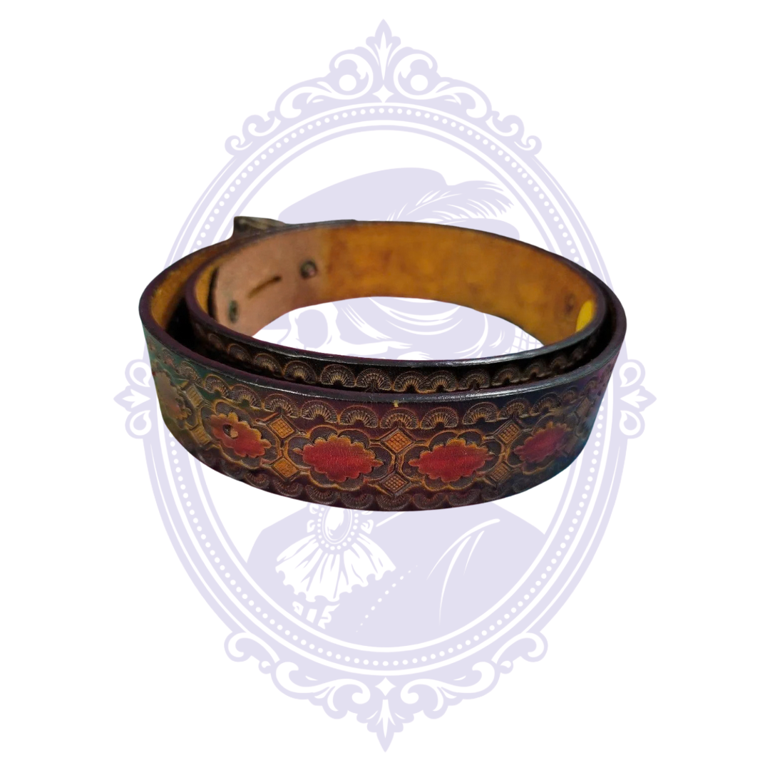 Angled display of brown tooled leather belt showing red floral medallions and dark scalloped tooling.
