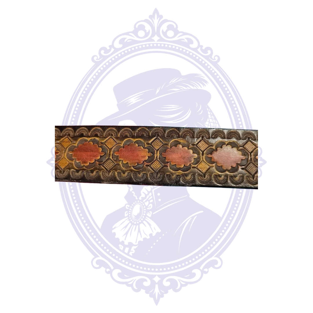 Flat close-up of brown leather belt showing repeated red floral medallions, geometric diamonds, and scalloped tooling.