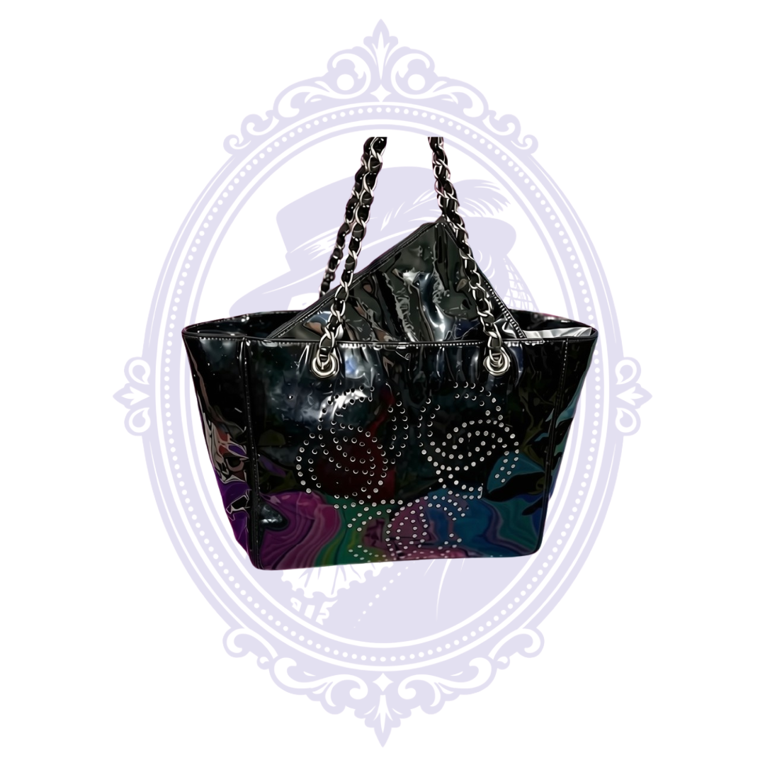 Vintage Chanel Triple Coco black patent leather tote with silver-tone chain straps and perforated CC motifs.