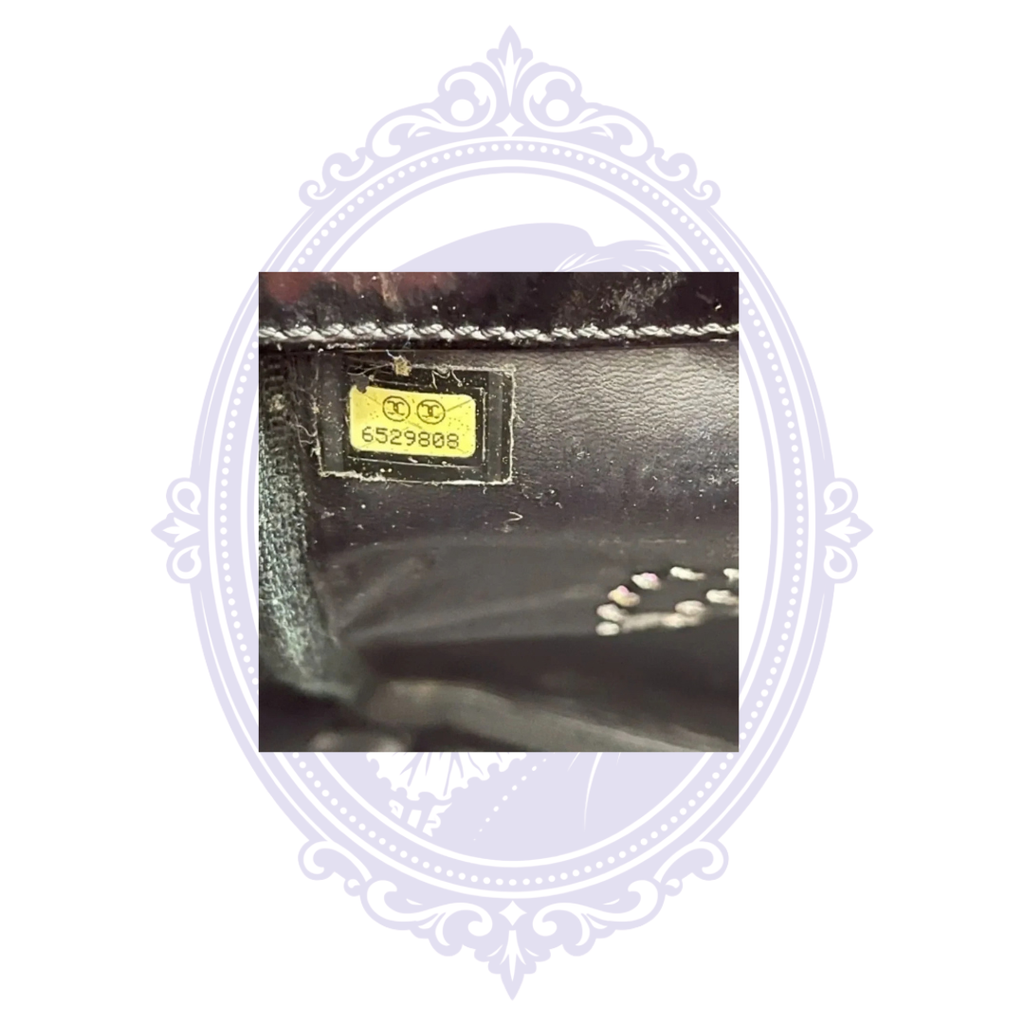Interior Chanel serial sticker number 6529808 on vintage Triple Coco black patent leather tote.