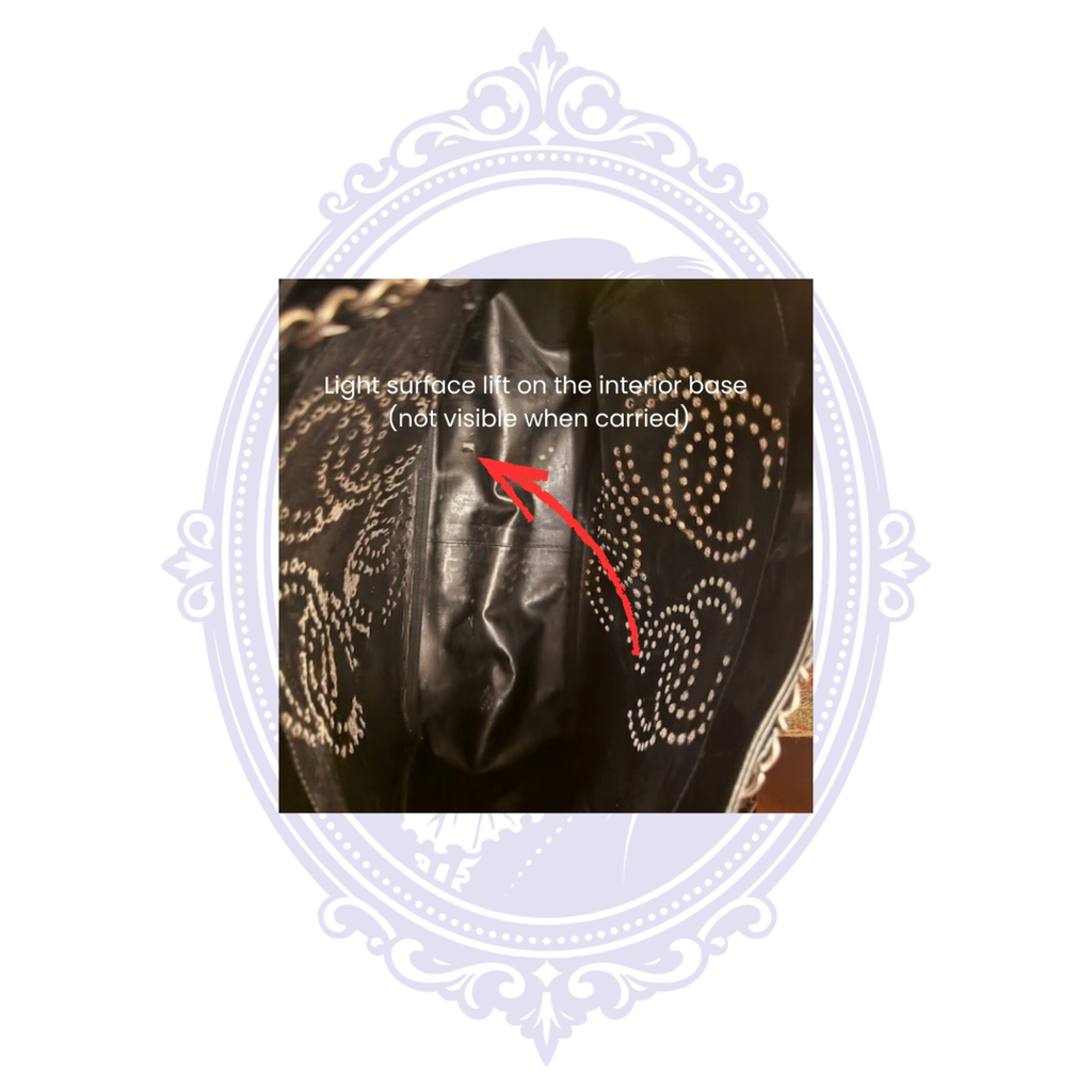 Interior base of vintage Chanel Triple Coco black patent leather tote showing disclosed area of light surface lifting.