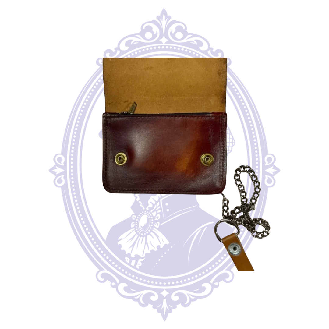 Open front flap of chestnut leather longhorn trucker wallet BBL-07 showing tan leather underside, brass-tone snap sockets and attached chain.