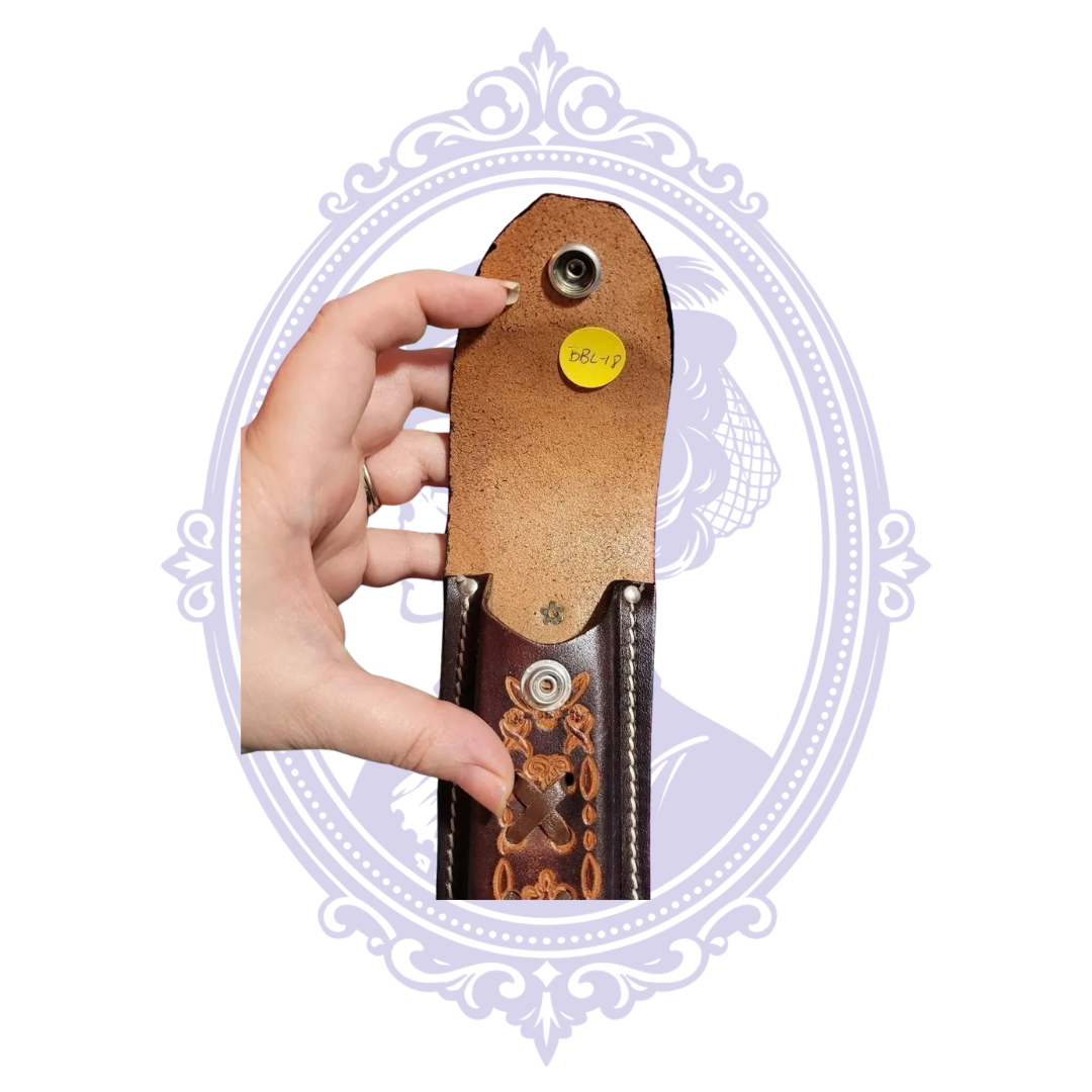 Open snap flap of Harley-Davidson winged emblem brown leather knife sheath, showing interior leather and original BBL-18 stock sticker.