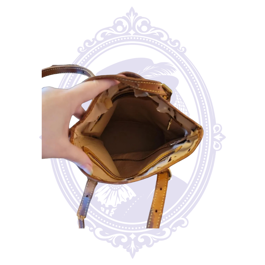 Interior of vintage Louis Vuitton Petit Bucket PM showing extensive peeling and deterioration of the lining.