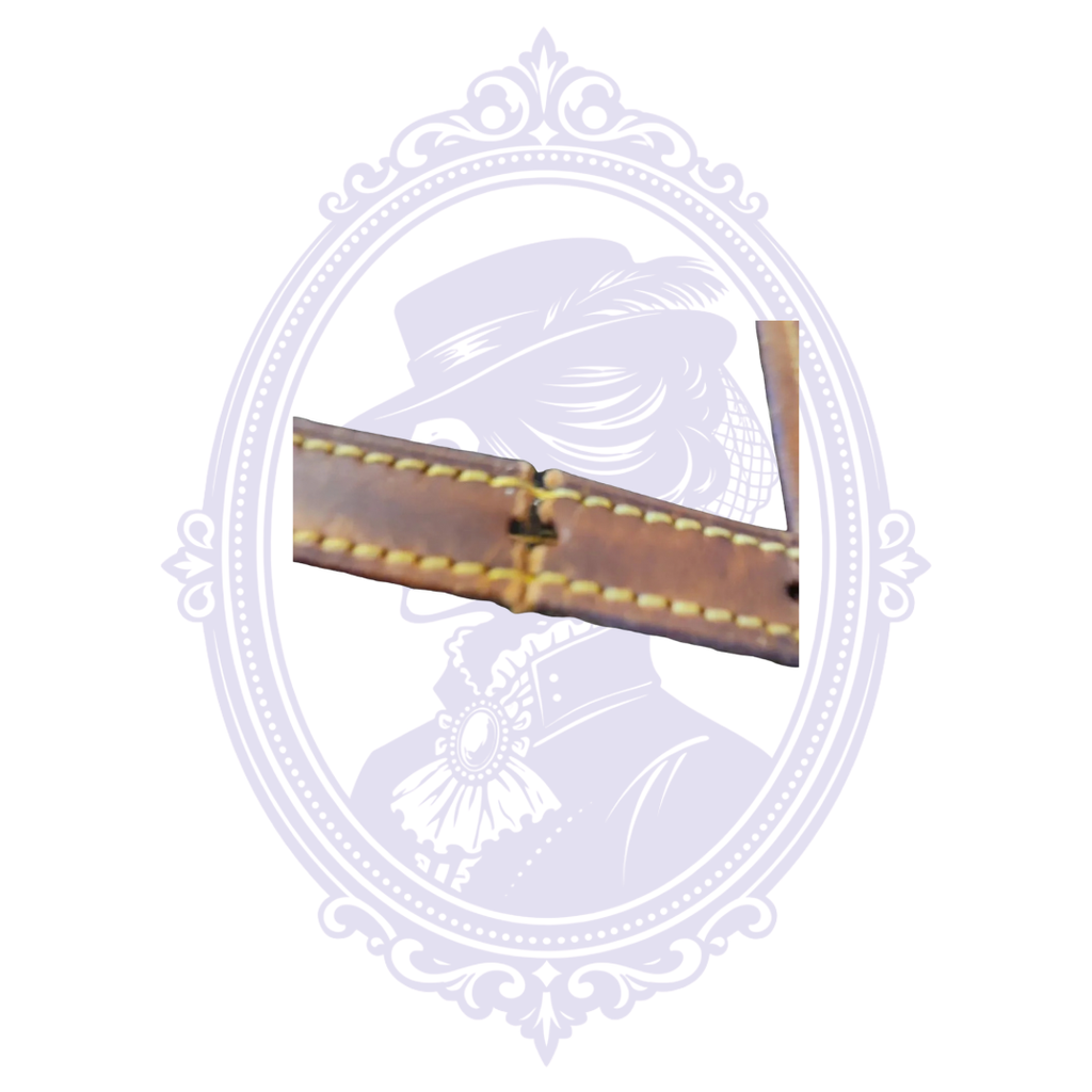 Close-up of damaged and split vachetta shoulder strap on vintage Louis Vuitton Petit Bucket PM.
