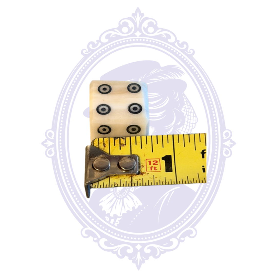 Genuine water buffalo bone die shown with measuring tape for approximate size.