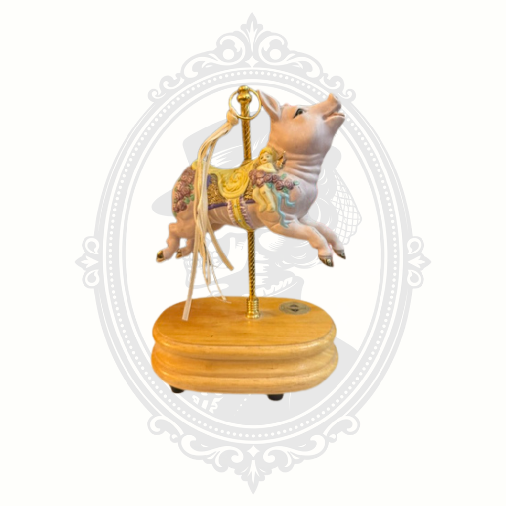 Whimsical carousel pig collectible detail with decorative floral accents and vintage-inspired craftsmanship.