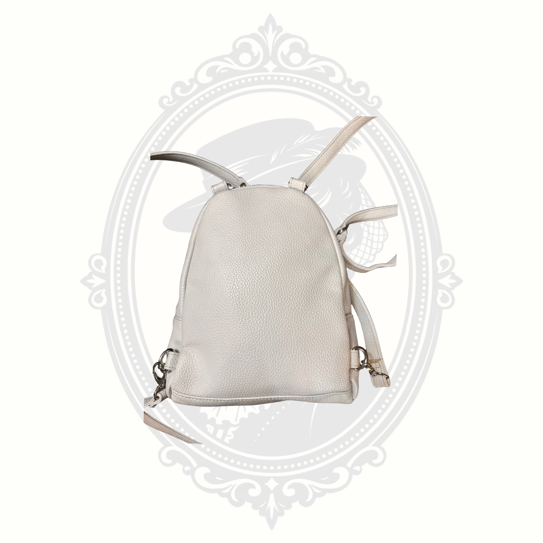 Back view of white mini backpack purse with adjustable straps and textured finish