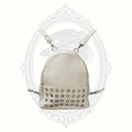 White mini backpack purse with silver grommet detailing and adjustable straps front view
