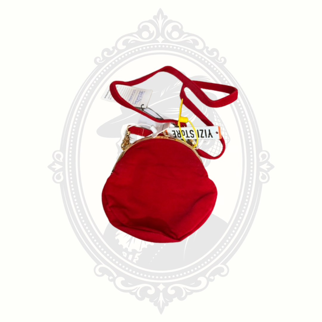 Back view of red velvet YIZI kisslock crossbody bag with strap and tags attached